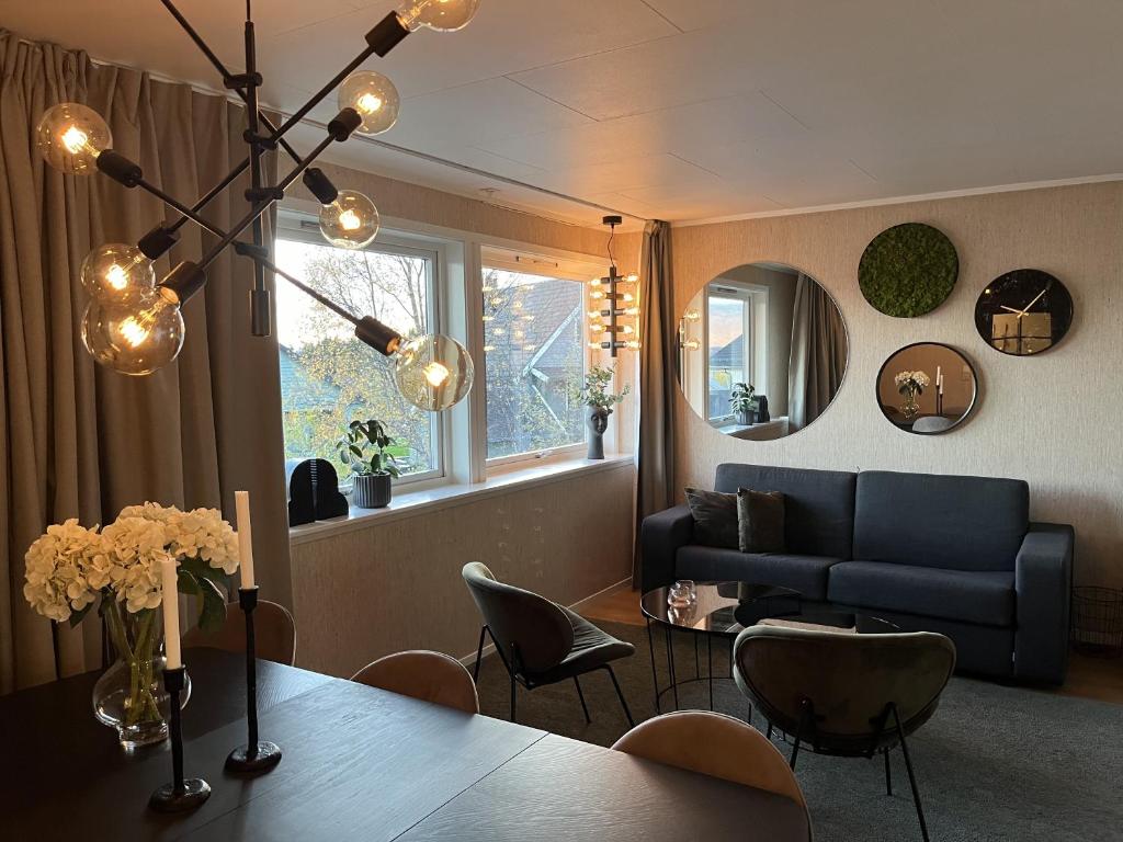 a living room with a table and a couch at g-Suites in Tromsø