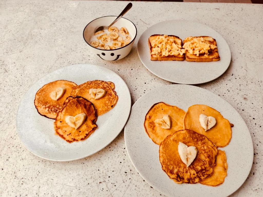 three plates of food on top of a table at Lazy Sunday Khaosan Hotel in Bangkok