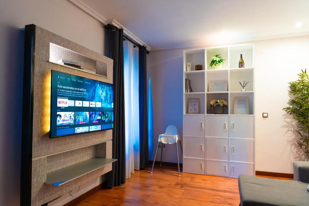 a living room with a flat screen tv on a wall at La Casa de los Osorios in León