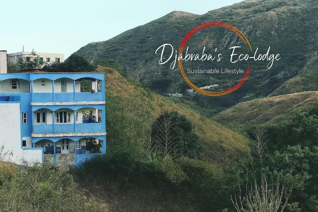 a blue building on the side of a hill at Djabraba's kA Marku e Maria in Vila Nova Sintra