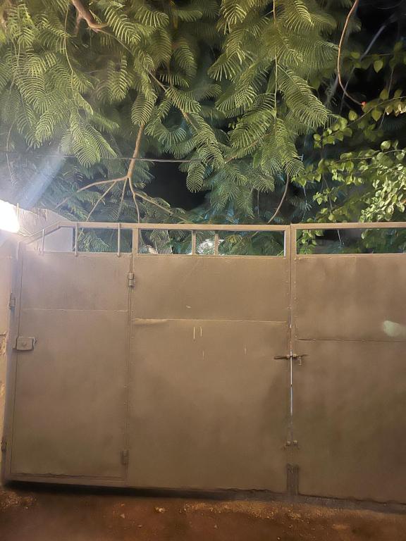 a wooden gate in front of a tree at pasha nungwi zanzibar in Nungwi