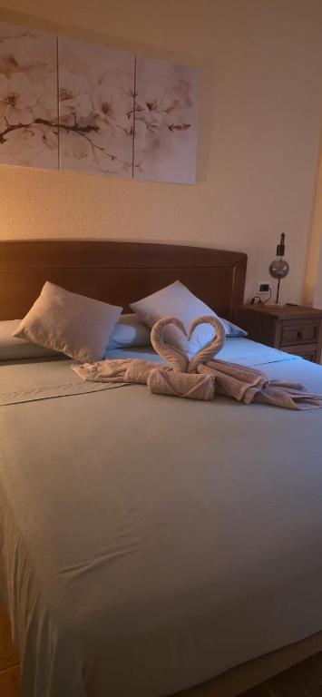 two towels in the shape of hearts on a bed at Casa Elba Candelaria in Candelaria