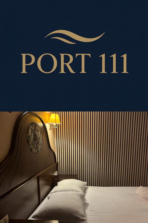 a bedroom with a part sign on the wall at Apartamenty Port 111 in Kołobrzeg
