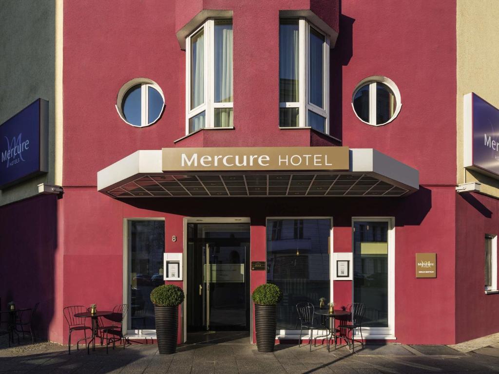 a red building with a sign that reads mercure hotel at Mercure Hotel Berlin Zentrum Superior in Berlin
