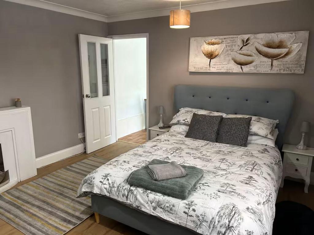 a bedroom with a large bed with a blanket at Emsworth Studio - With Hot tub only Oct to April in Emsworth