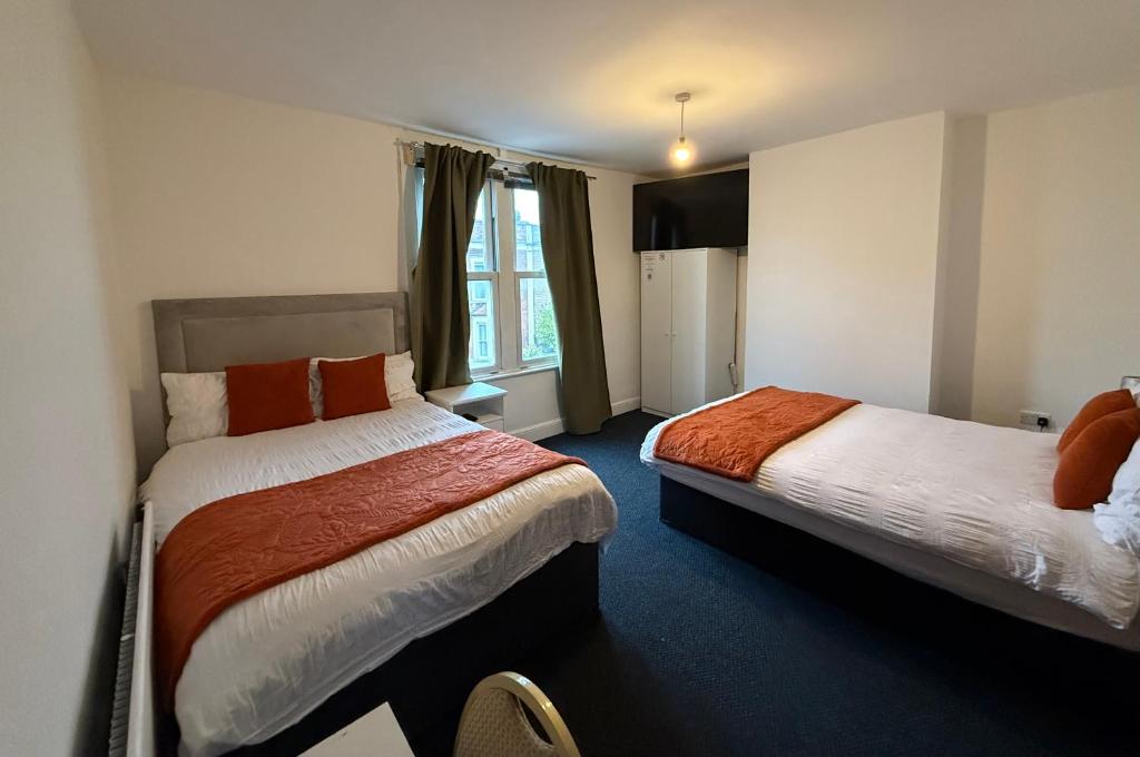 a hotel room with two beds and a window at Saint Paul 05 in Bristol