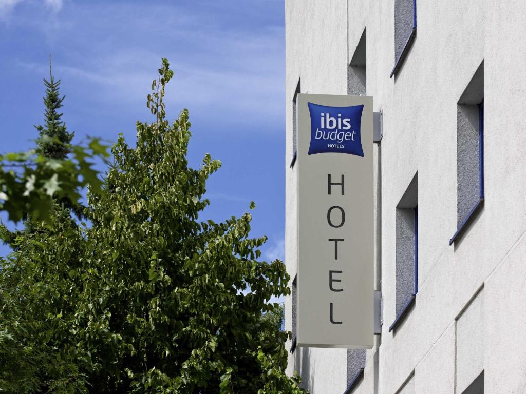 a sign on the side of a building with ahs college at ibis budget Hamburg Altona in Hamburg