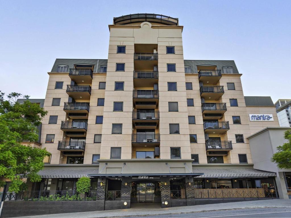 a large building with balconies on the side of it at Mantra on Hay Perth in Perth