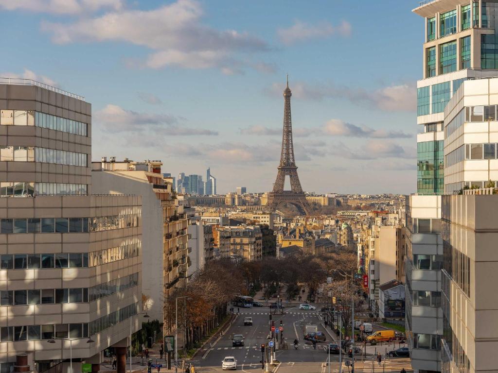 a city with the eiffel tower in the background at Mercure Paris Gare Montparnasse TGV in Paris
