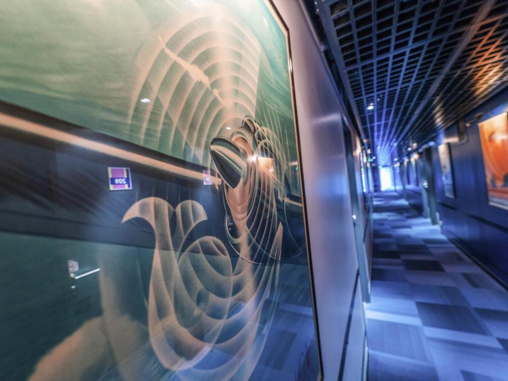 a train with graffiti on the side of it at ibis Styles Paris Velizy in Vélizy-Villacoublay