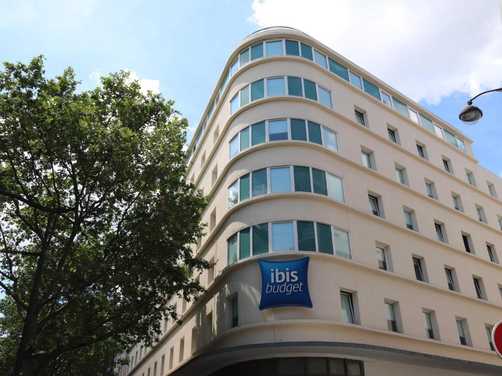 a tall white building with a bus bucket sign on it at ibis Budget Paris La Villette 19ème in Paris