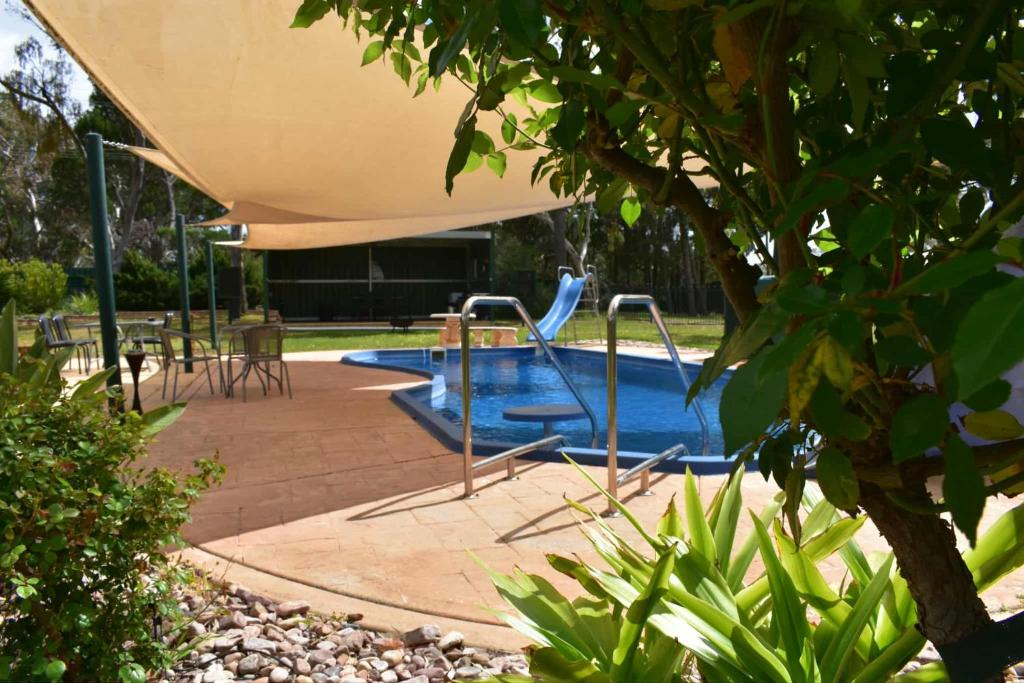 a swimming pool with a slide in a yard at Lyndoch Retreat, 2BR with Pool, BBQ & Fire Pit in Altona