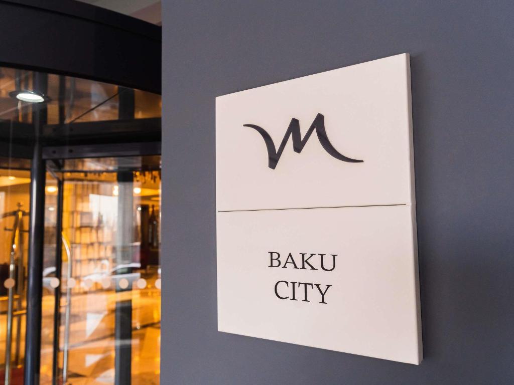 a sign on a wall in front of a building at Mercure Baku City in Baku