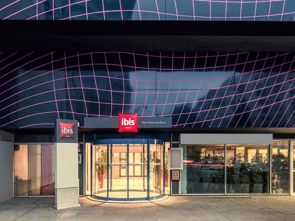 un bâtiment avec un panneau d'affichage devant lui dans l'établissement ibis Paris porte de Bercy, à Charenton-le-Pont