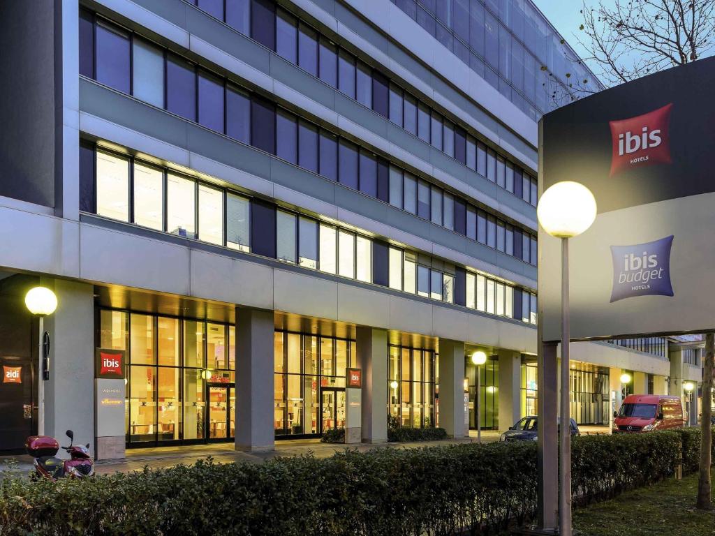 a lit up building with a lot of windows at Ibis Wien Messe in Vienna