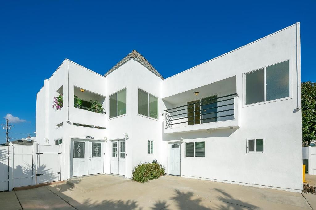 a white house with a garage at Sunny Days in Newport Heights