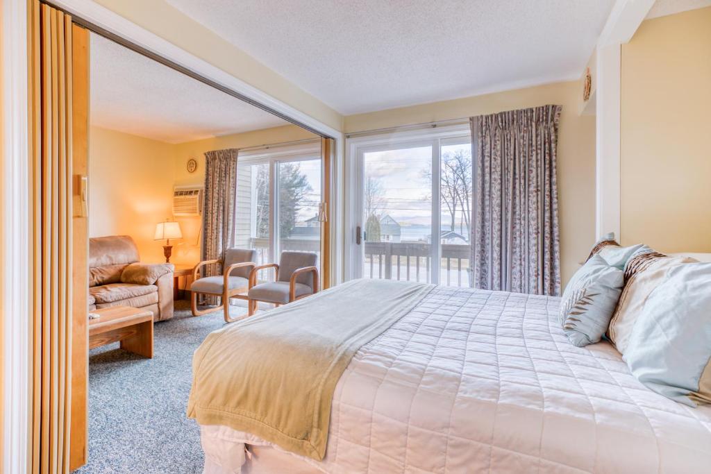 a bedroom with a bed and a large window at Misty Harbor Resort - Unit 103 in Dockham Shore
