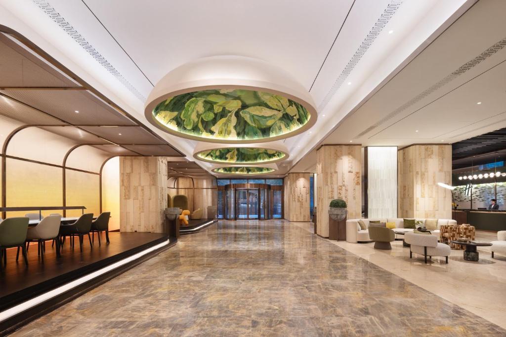 a lobby with a large painting on the ceiling at Holiday Inn Shanghai Minhang Center by IHG in Shanghai