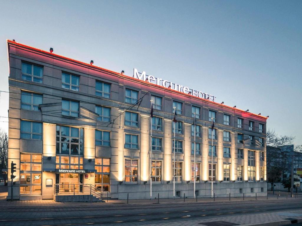 a large building with a sign on top of it at Mercure Montpellier Centre Antigone in Montpellier