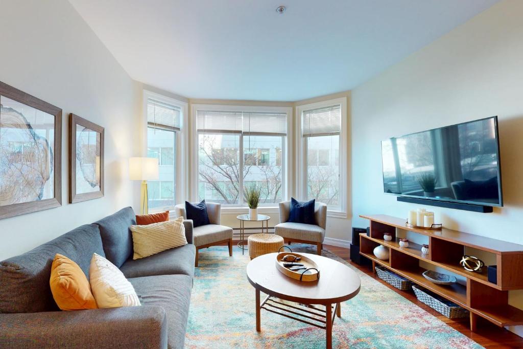 a living room with a couch and a tv at Belltown Escape in Seattle