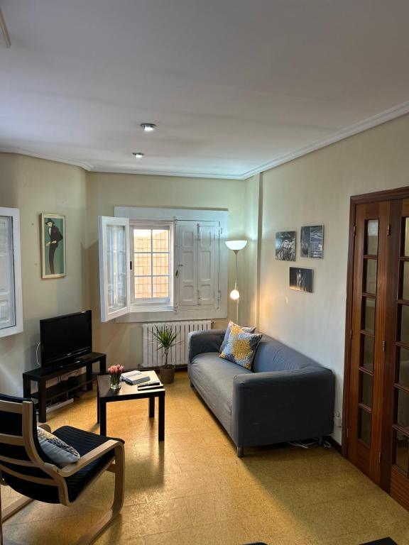 a living room with a couch and a tv at Casa Lolita / Camino de Santiago / Porriño in Porriño