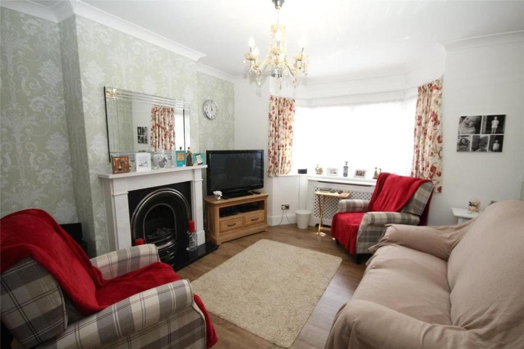 a living room with a couch and a television at Spacious 4-Bed House in Welling - Free parking in Welling