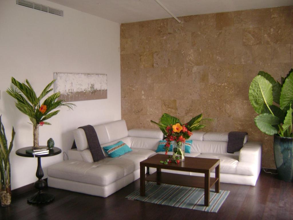 a living room with a white couch and a table at Zen Retreat City Centre in San Juan