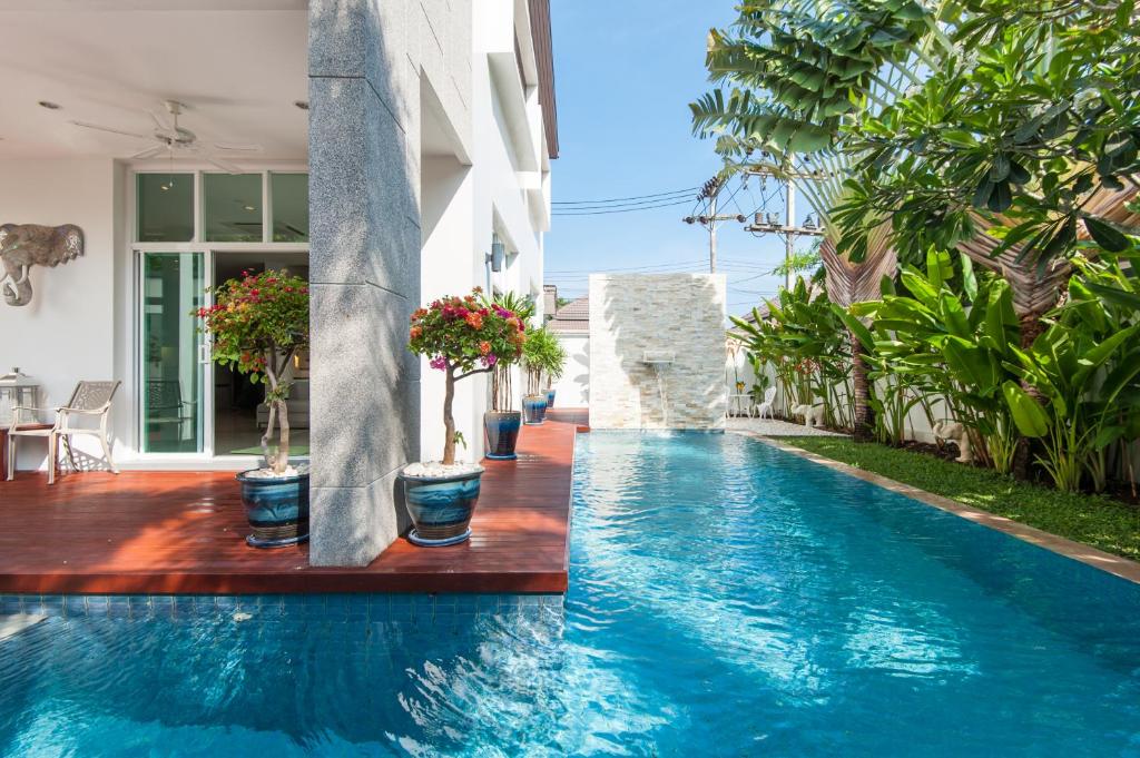 a swimming pool with blue water in a house at Villa Paradiso in Bang Tao Beach