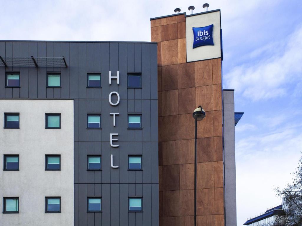 a building with a blue sign on the side of it at ibis budget London Hounslow in Hounslow