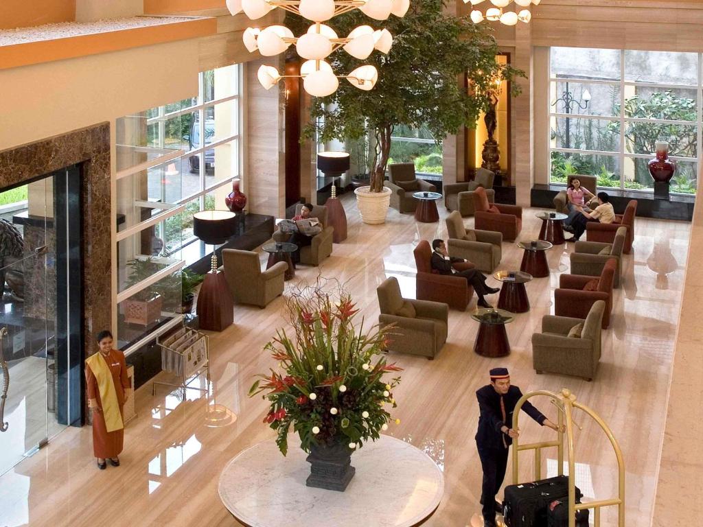 an overhead view of a lobby with people sitting at Novotel Semarang in Semarang