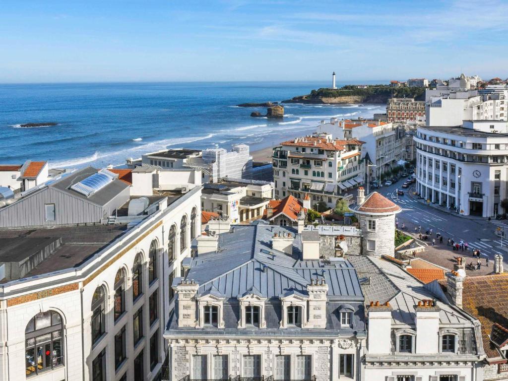 an aerial view of a city with the ocean at Mercure Président Biarritz Plage in Biarritz