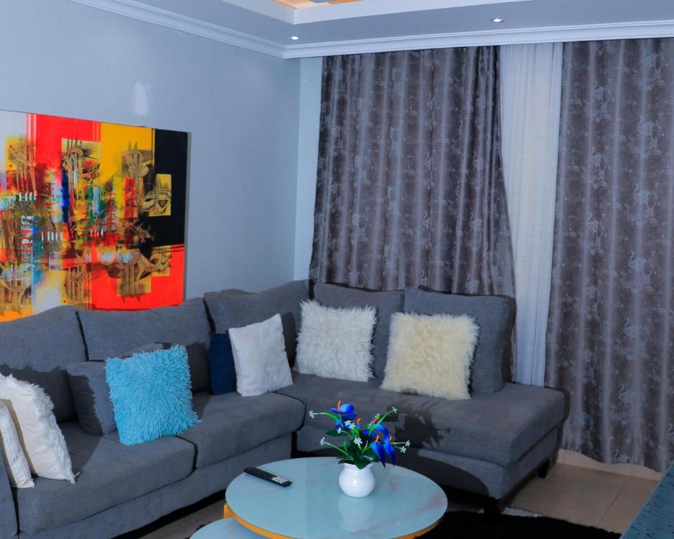a living room with a couch and a table at Greatwall in Athi River