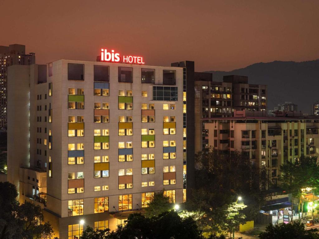 a lit up building with a bus hotel sign on it at ibis Thane - An Accor Brand in Thane