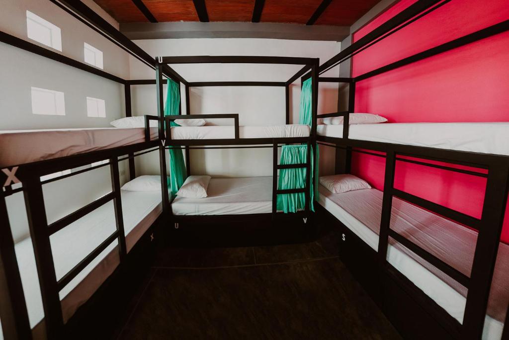 a group of bunk beds in a room with red lighting at Imagine hostel in Santa Marta