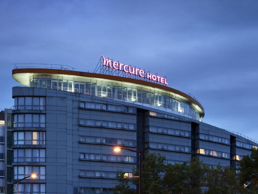 a building with a sign on top of it at Mercure Paris 19 Philharmonie La Villette in Paris