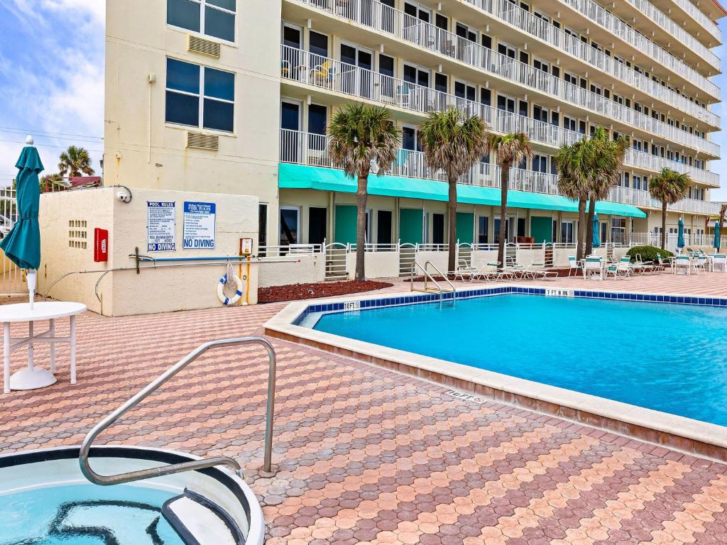 a swimming pool in front of a building at Harbour Beach Resort 503 in Daytona Beach