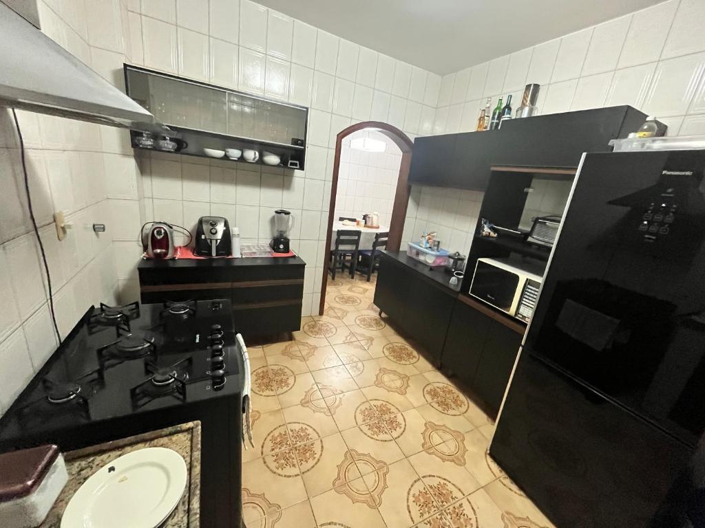 a kitchen with a stove and a sink in it at COP 30 Apartamento Cobertura Duplex in Belém