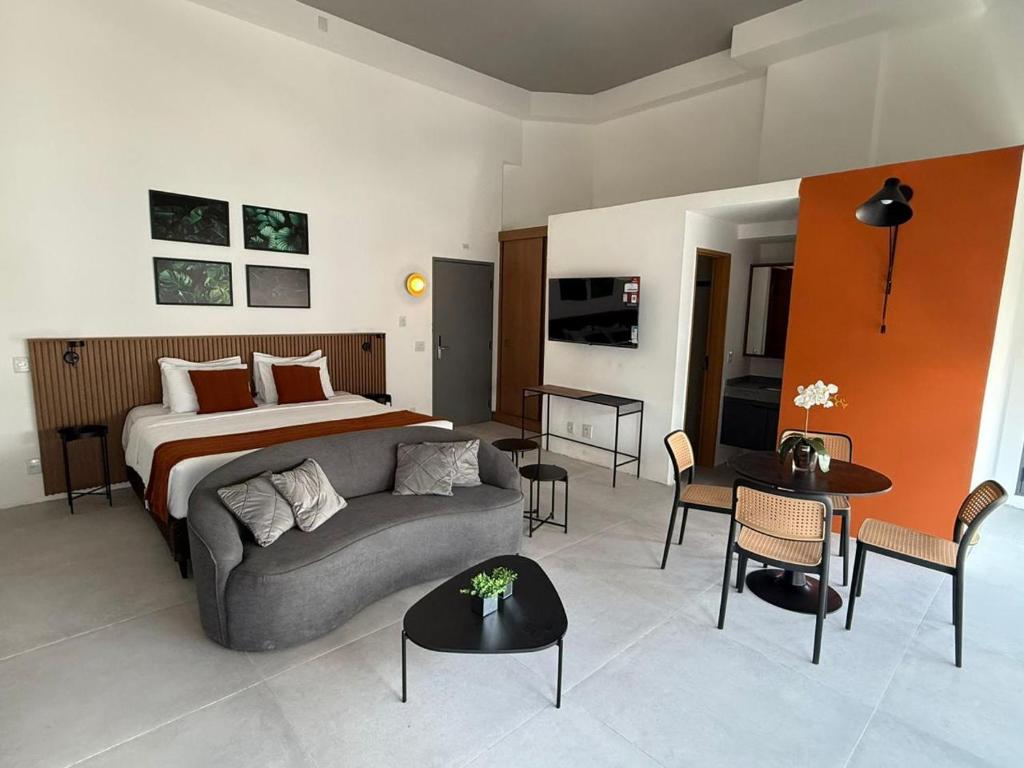 a living room with a couch and a bed at Residence X in Sao Paulo