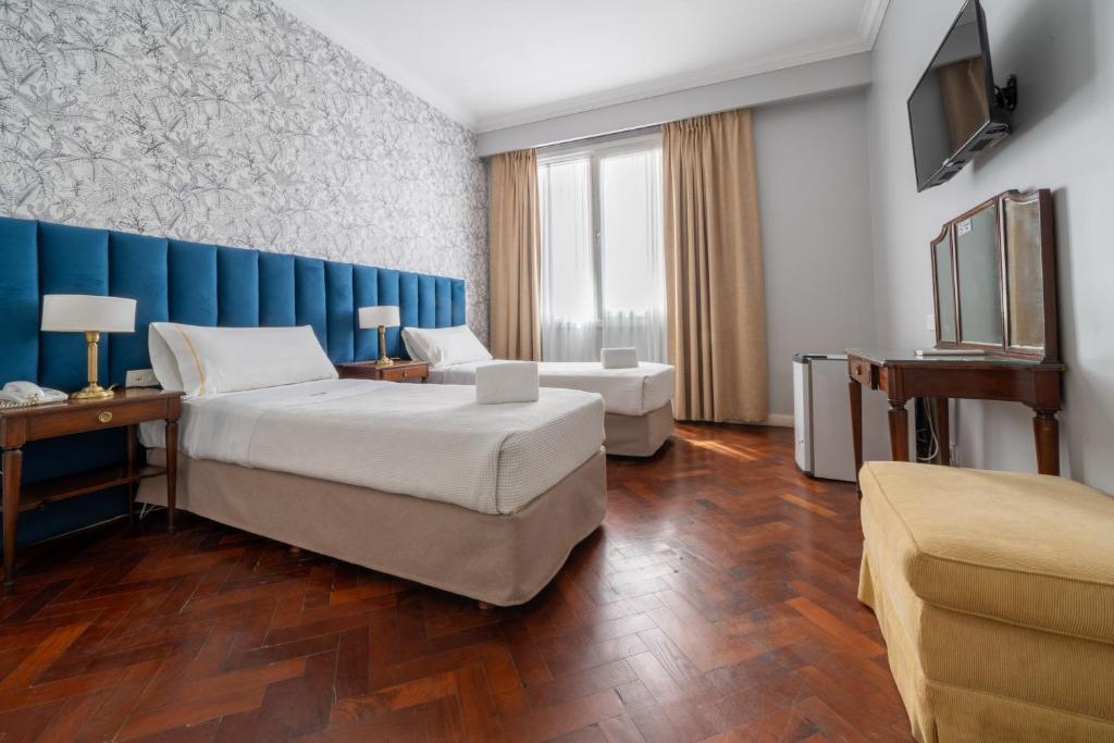 a hotel room with a bed and a couch at HOTEL REGIS in Buenos Aires
