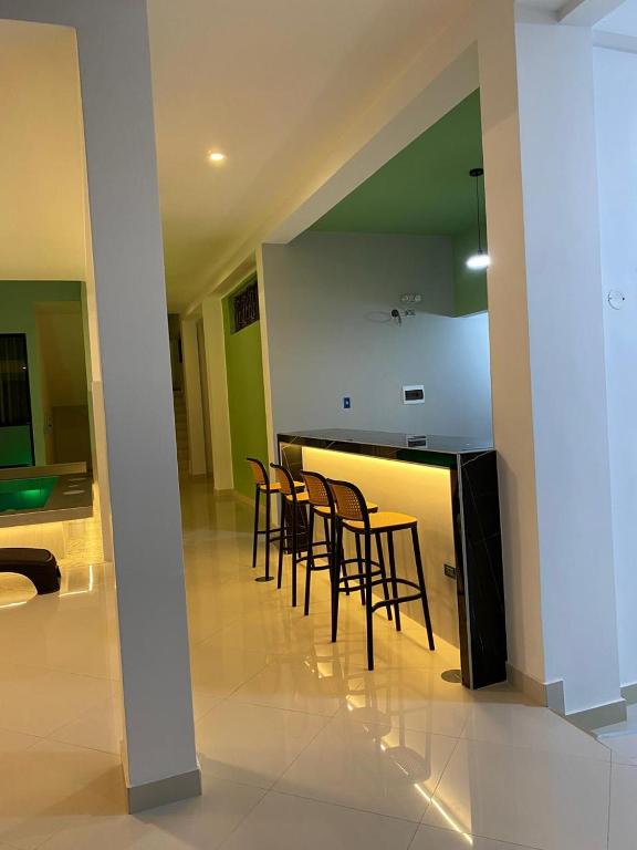 a kitchen with chairs and a table in a room at Hotel Raymondi in Tarapoto