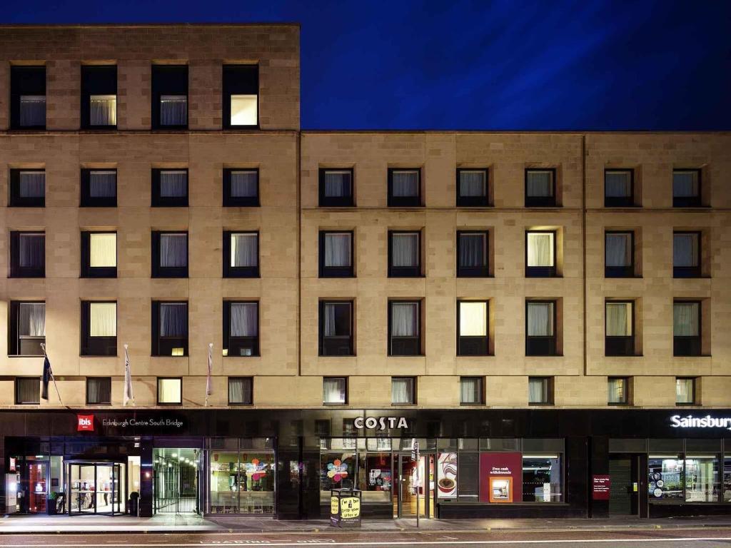 a building on a street in front of a store at ibis Edinburgh Centre South Bridge – Royal Mile in Edinburgh