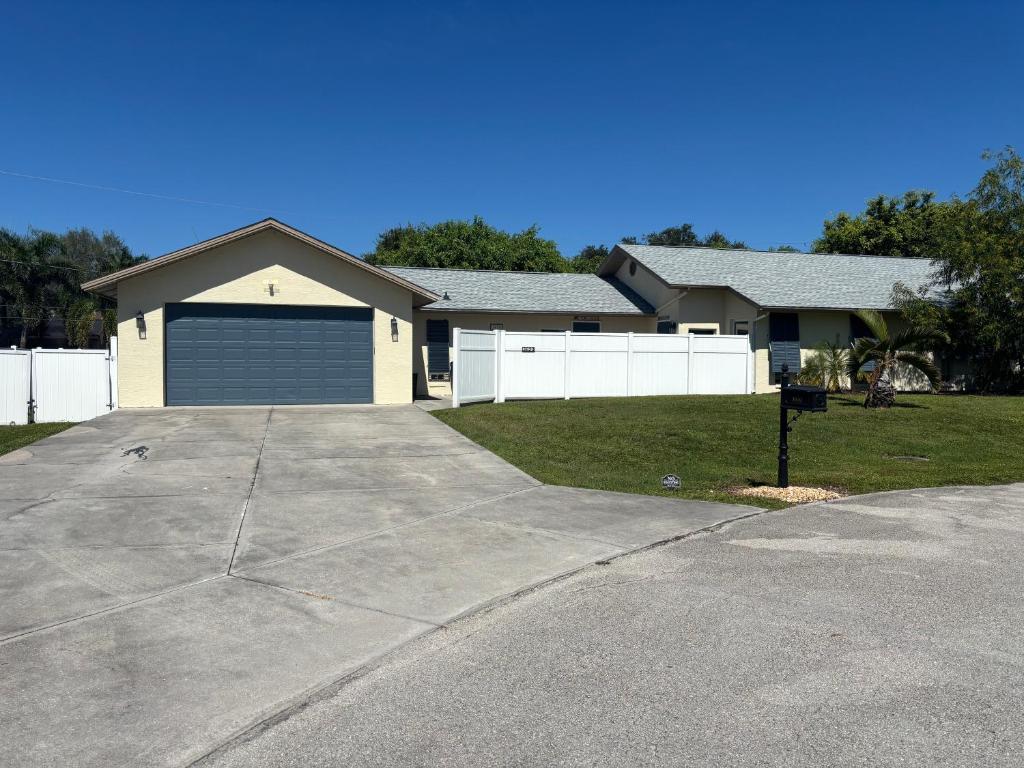 a house with a garage and a driveway at Sea Urchin - Amazing Private Suite Large Bath 3.3mi 2 Beach in Bonita Springs