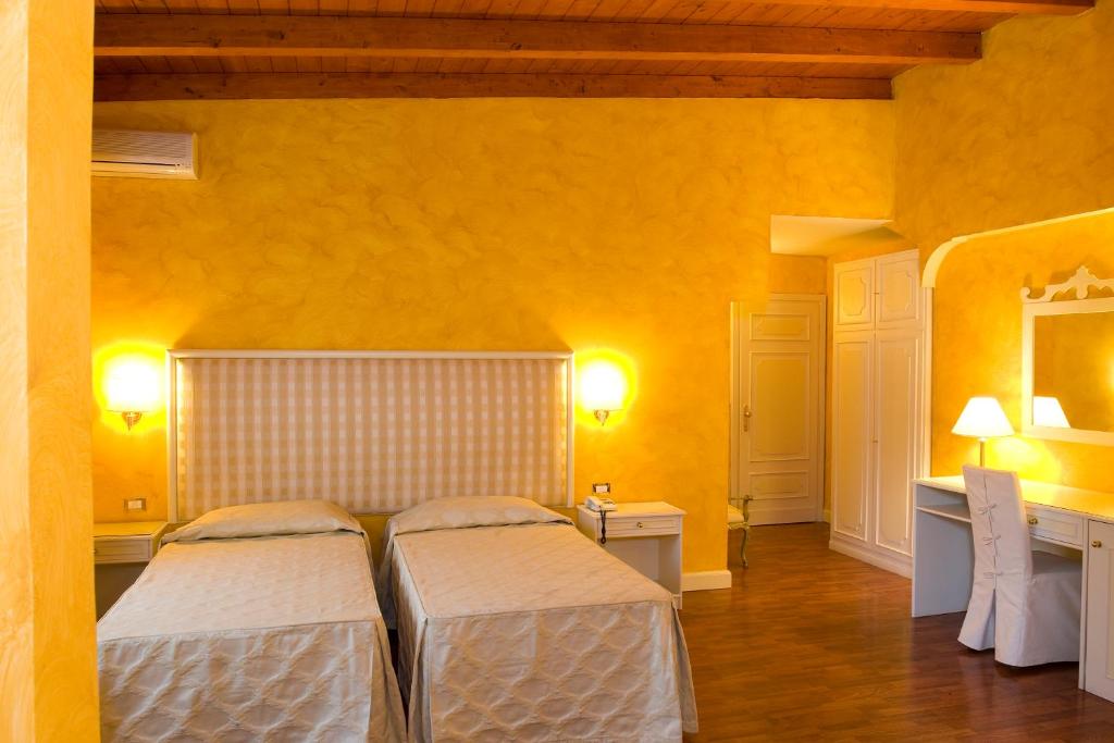 Voodi või voodid majutusasutuse Park Hotel Villaferrata toas