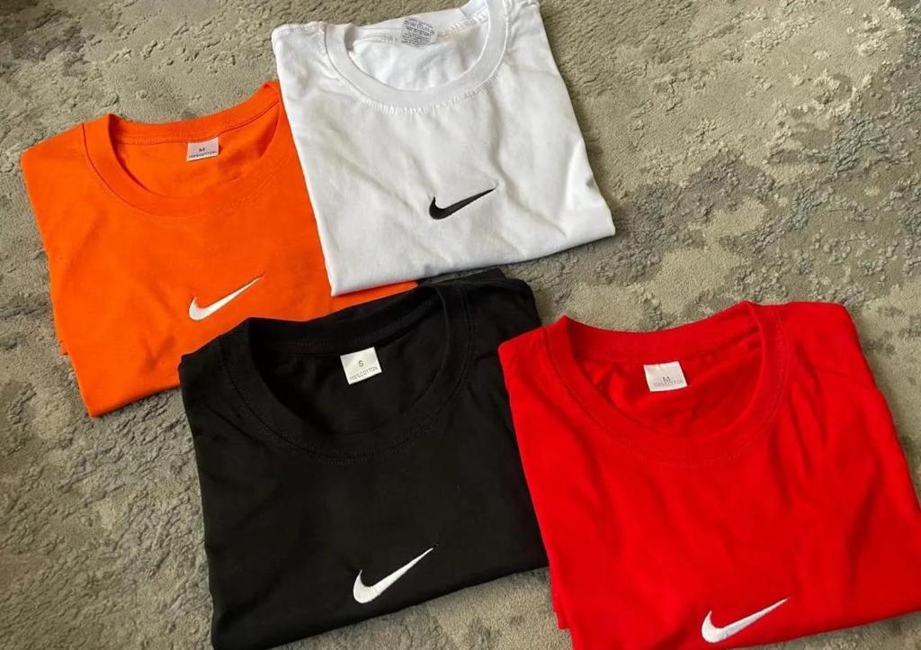 four different colored t shirts sitting on the ground at The Cosy Retreat Guest House in Gaborone