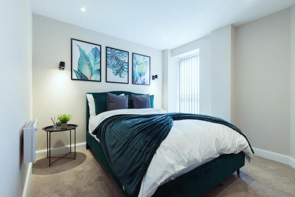a bedroom with a bed and a table in it at Stylish Central Leeds Arena Apartment Free Parking in Leeds