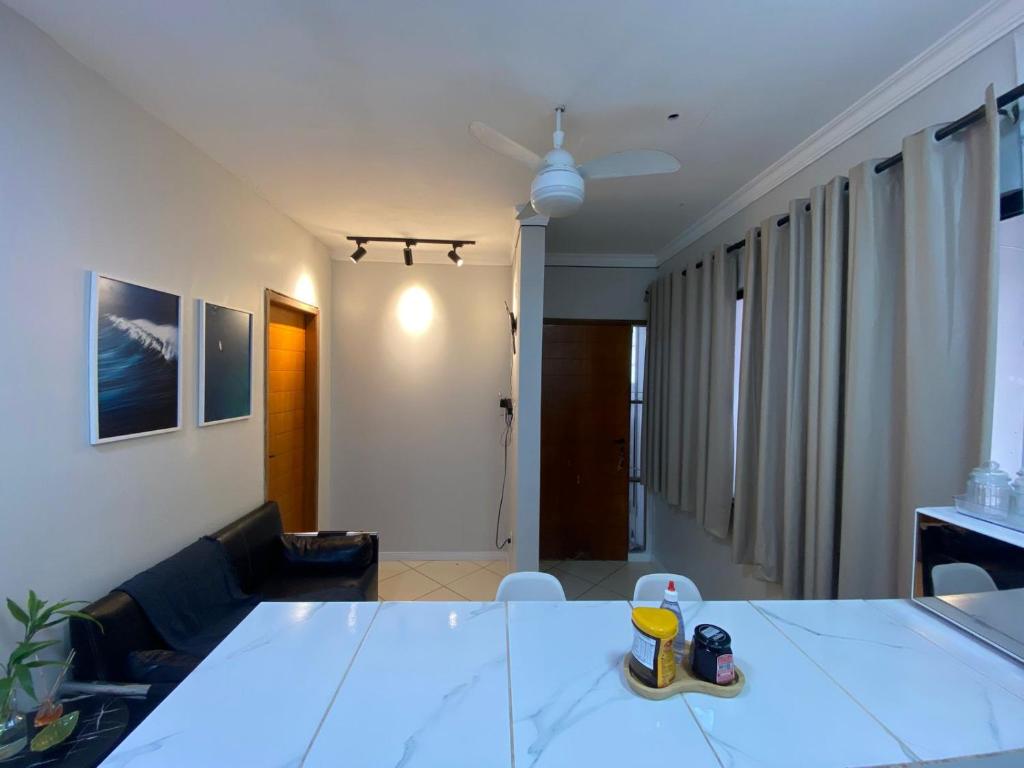 a living room with a large white table in a room at Apartamento 03 São Brás COP30 in Belém