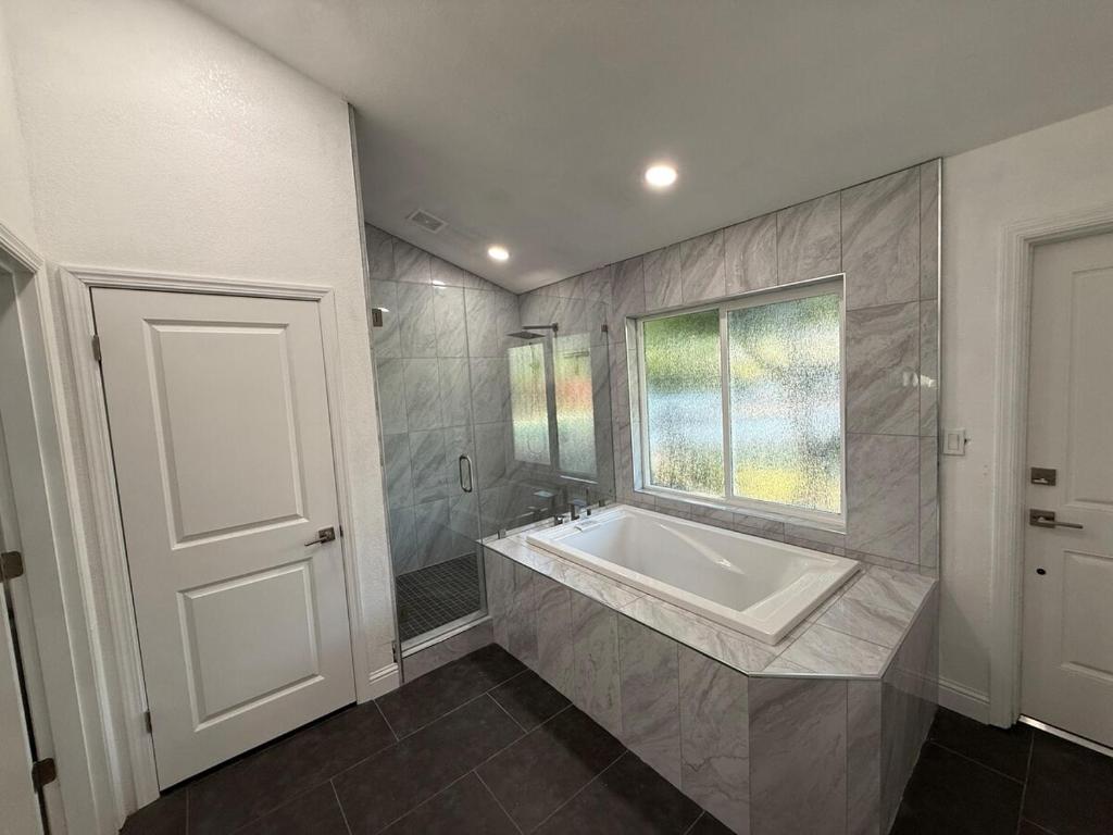 a bathroom with a large sink and a window at New Unique Home Near Airport in Fresno