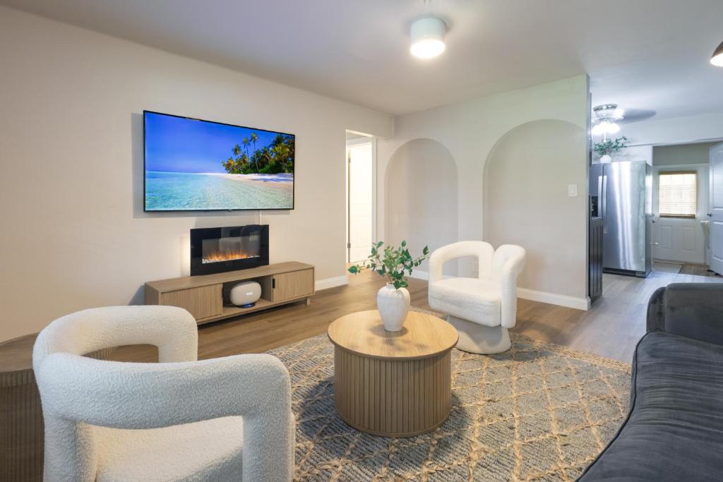 a living room with a couch and a tv at Biva Luxe in West Palm Beach