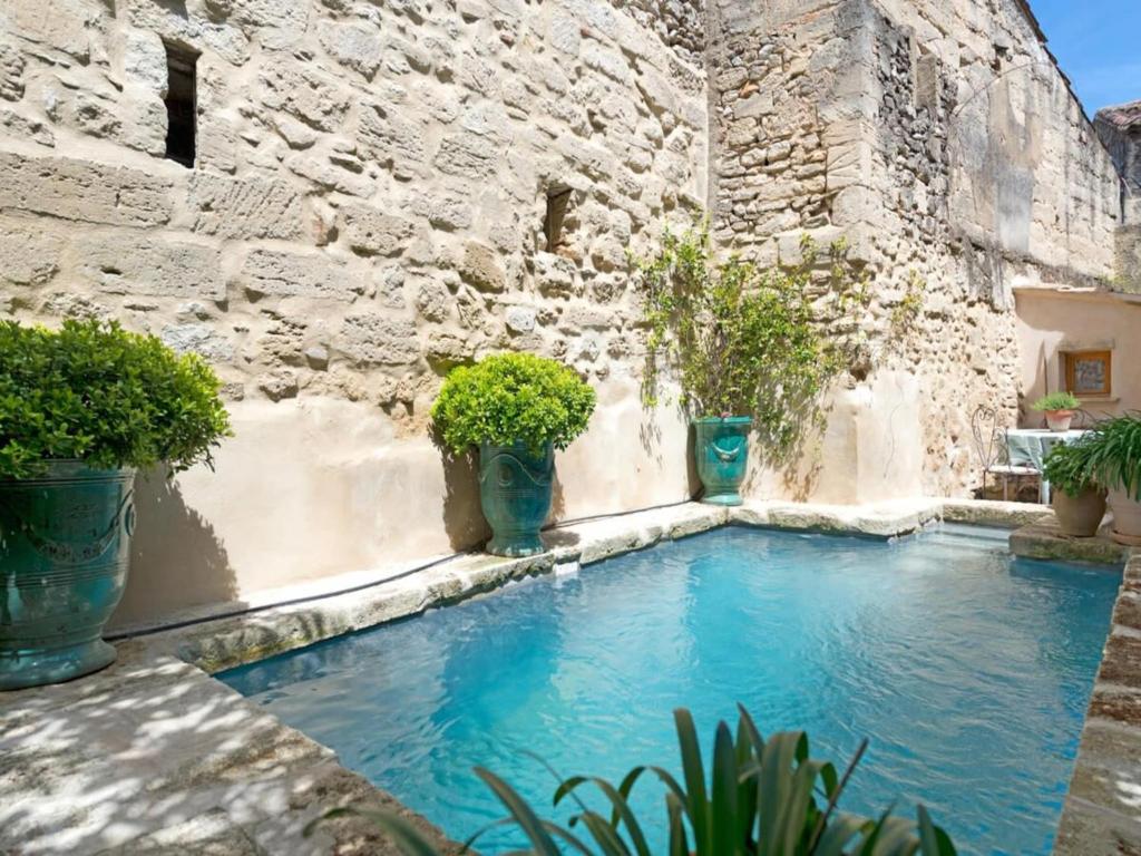 una piscina en un edificio con macetas en Heated Pool Apartment in Uzes, en Uzès
