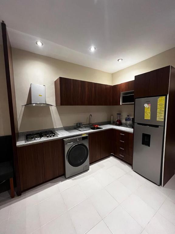 a kitchen with a stove and a refrigerator at Apartamento Valle in Puerto Vallarta